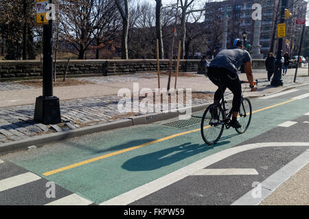 Cyclist zooming by on a city bike path. Stock Photo