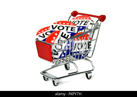 Election vote buttons in a shopping cart isolated on white. Stock Photo