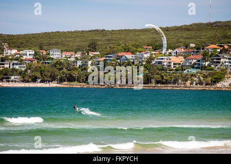 Sydney, Australia - November 10, 2015: Unidentified kite surfer rides into the ocean on his kite near Manly Beach Stock Photo