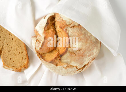 freshly baked loaf of bread on white napkin Stock Photo