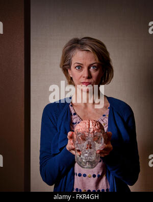 Caucasian woman holding model skull Stock Photo