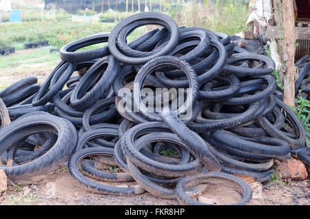 Pile of used rubber tyres on the floor Stock Photo