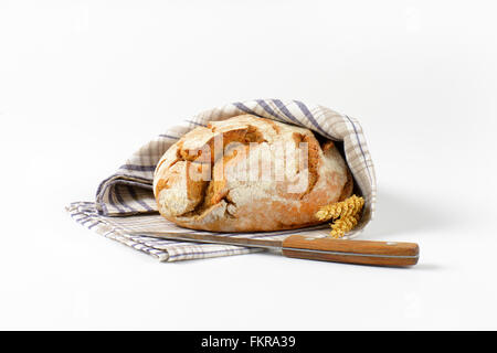 Fresh Bread Covered With A Checkered Towel On A Rustic Kitchen