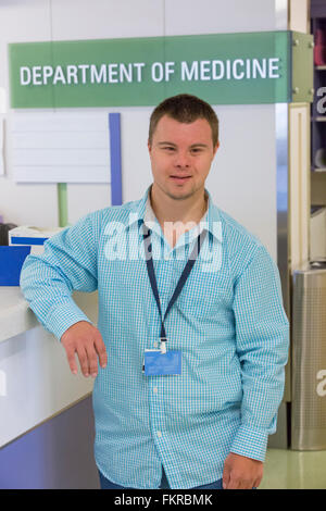 Caucasian man with Down Syndrome working in hospital Stock Photo
