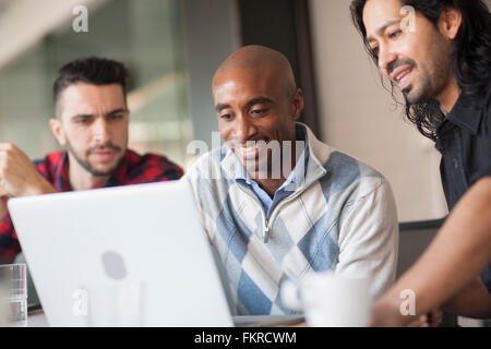 Businessmen using laptop in office Stock Photo