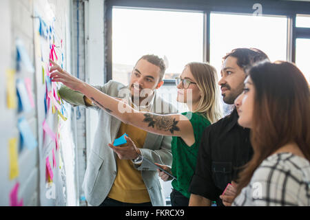 Business people using adhesive notes in office Stock Photo