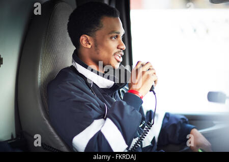 Mixed race paramedic using walkie-talkie Stock Photo