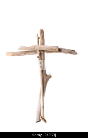 Christian Cross made from sun bleached drift wood symbolizing purity and humility isolated on white background Stock Photo