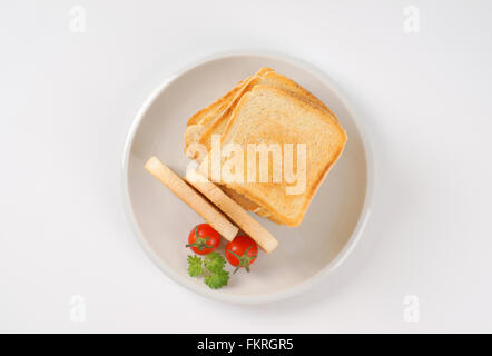 plate of freshly made toasts on white background Stock Photo
