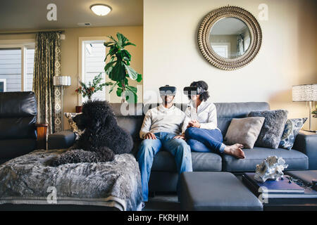 Couple using virtual reality goggles Stock Photo