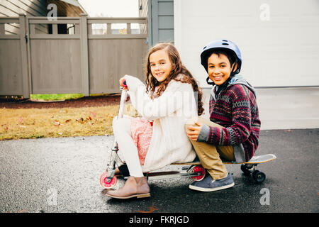 Mixed race children playing outdoors Stock Photo