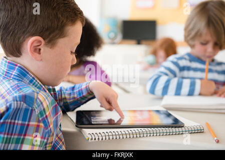 Student using digital tablet in classroom Stock Photo