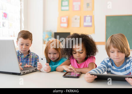 Students using technology in classroom Stock Photo