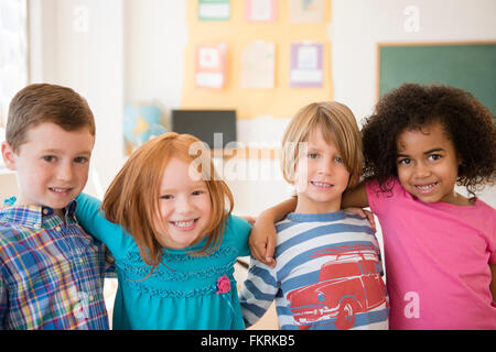 Students smiling in classroom Stock Photo