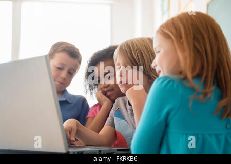 Students using laptop in classroom Stock Photo