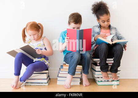 Barefoot students reading books Stock Photo