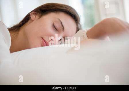 Native American woman sleeping in bed Stock Photo