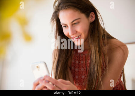 Native American woman using cell phone Stock Photo