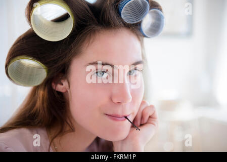 Native American woman with curlers in hair