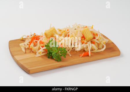 carrot and bean sprouts salad on wooden cutting board Stock Photo