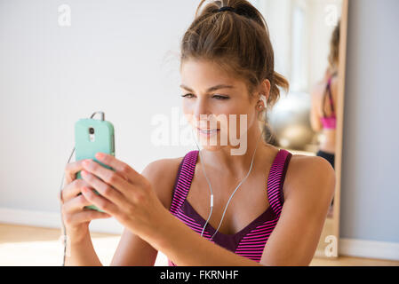 Mixed race woman using cell phone Stock Photo