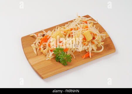 carrot and bean sprouts salad on wooden cutting board Stock Photo