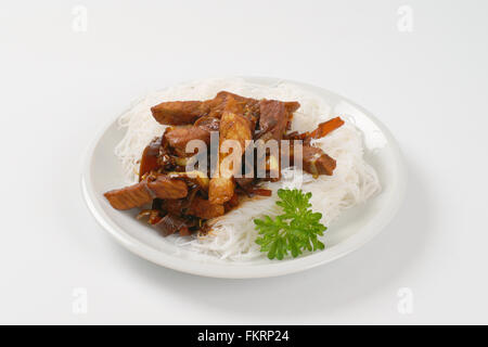 plate of roasted meat, ear mushrooms and rice noodles on white background Stock Photo