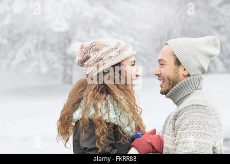 Couple smiling in snow Stock Photo