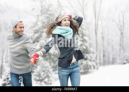 Couple walking in snow Stock Photo