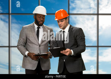 Two architects on sky background. Stock Photo