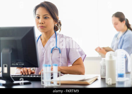 Nurse using computer in hospital Stock Photo