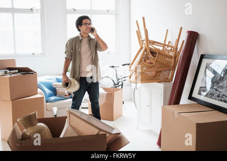 Mixed race man unpacking in new home Stock Photo