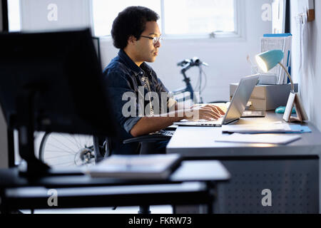 Mixed race businessman working in office Stock Photo