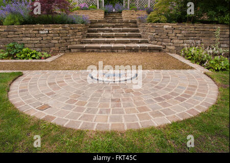 Pebble mosaic, paving, plants, steps, stone wall and terracing - traditional, designed, landscaped, garden, Burley-in-Wharfedale, Yorkshire, England. Stock Photo