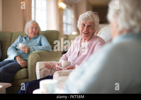 Older Caucasian women talking in nursing home Stock Photo
