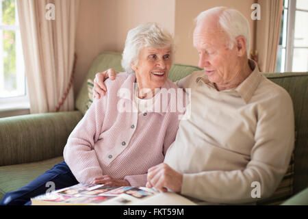 Older Caucasian couple looking at photo album Stock Photo
