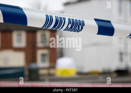 Police tape at the scene of a street crime put in place during an investigation on a London street Stock Photo