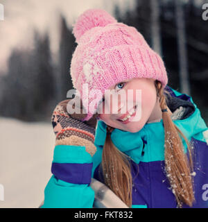 Caucasian teenage girl wearing beanie hat in snow