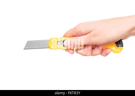 Stationery knife in the hand. Stock Photo