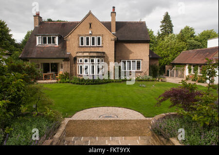 Arts and Crafts house with designed, landscaped, beautiful, traditional, well-kept garden, in summer - Burley-in-Wharfedale, West Yorkshire, England. Stock Photo