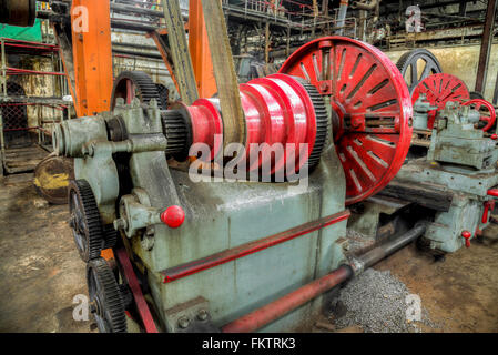 Old lathe driven by belt transmission with different  gearing shaft in Gondang Baru sugar factory, Indonesia Stock Photo