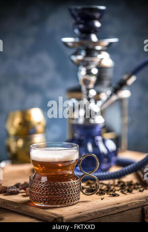 Cup of tea with vintage glass-holder on wooden table Stock Photo