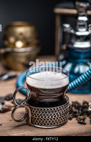 Cup of tea with glass-holder on wooden table Stock Photo