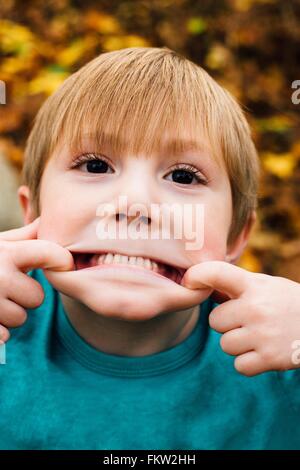 Portrait of young boy pulling face, close-up Stock Photo