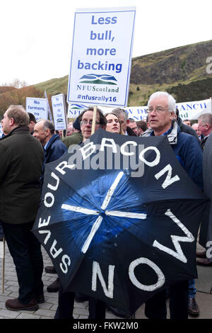 Edinburgh, Scotland, UK. 10th March, 2016. Demonstrators hold banners during the protest by farmers outside the Scottish Parliament over delays in farm subsidy payments, Credit:  Ken Jack / Alamy Live News Stock Photo