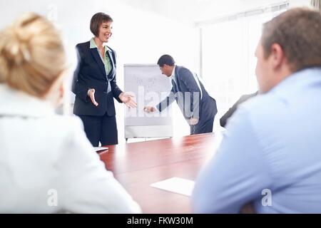 Over shoulder view of colleagues in conference room watching presentation Stock Photo