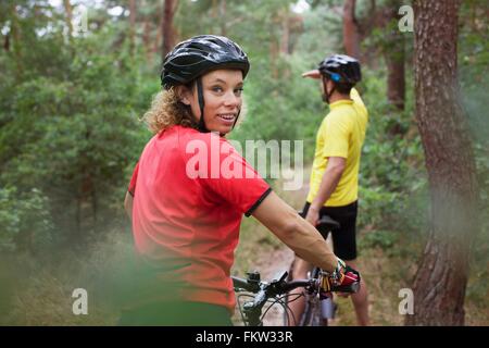 Mountain biking couple biking on forest trail Stock Photo