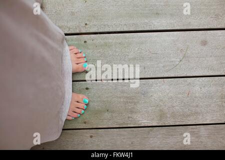 Overhead view of female toes painted with turquoise nail varnish Stock Photo