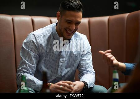 Man shuffling playing cards in game at traditional UK pub Stock Photo