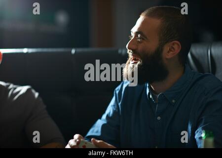 Man shuffling playing cards in traditional UK pub Stock Photo